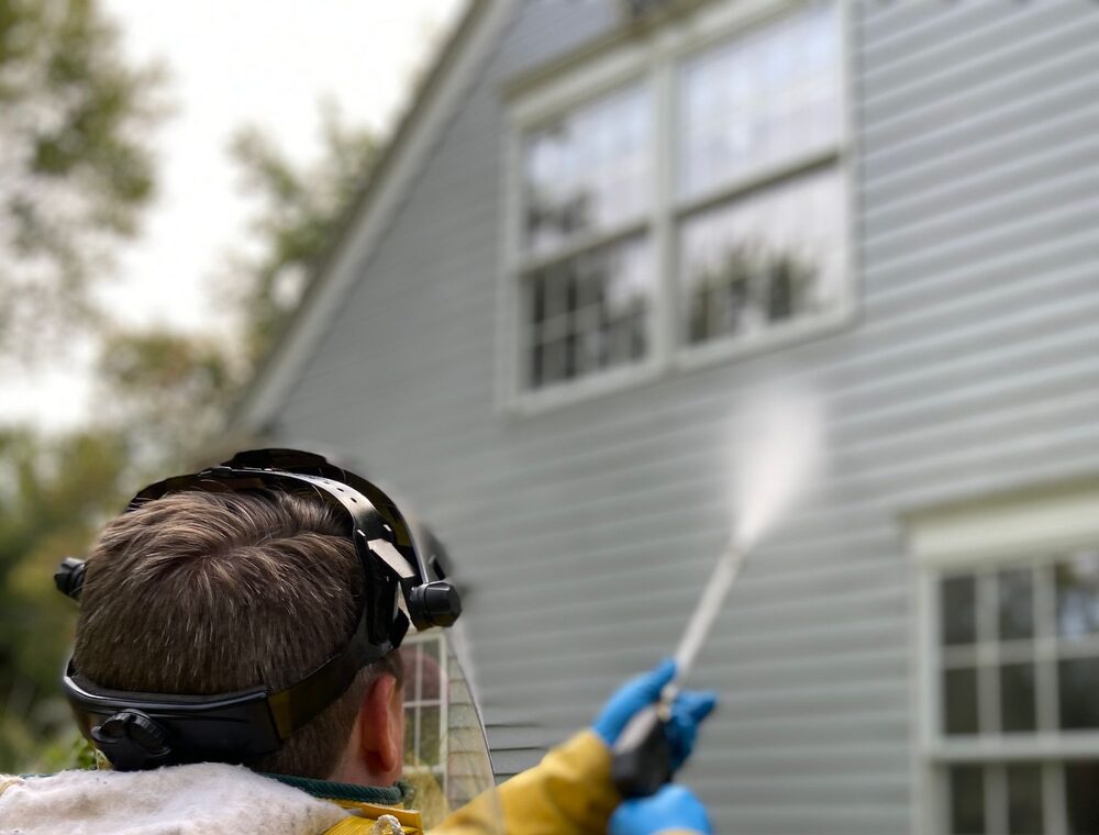 Soft washing house siding with protective technique